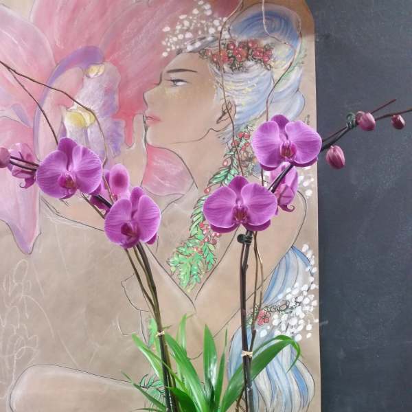 Purple orchids in a rectangular planter with assorted green plants