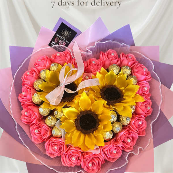 Heart-shaped bouquet of pink roses with sunflowers and chocolates