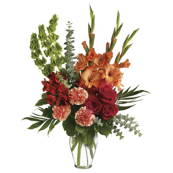 Tall bouquet of orange gladiolus, red roses, and carnations in a clear vase
