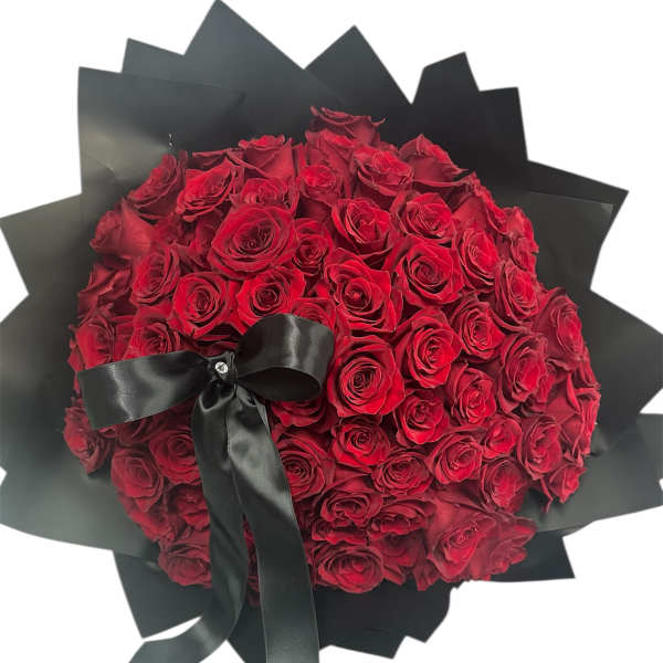 Large bouquet of red roses wrapped in black paper with a black ribbon