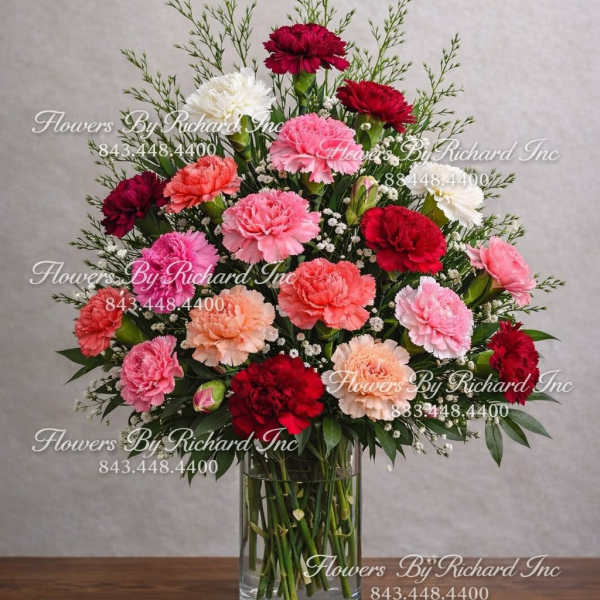 Mixed carnations in a clear glass vase