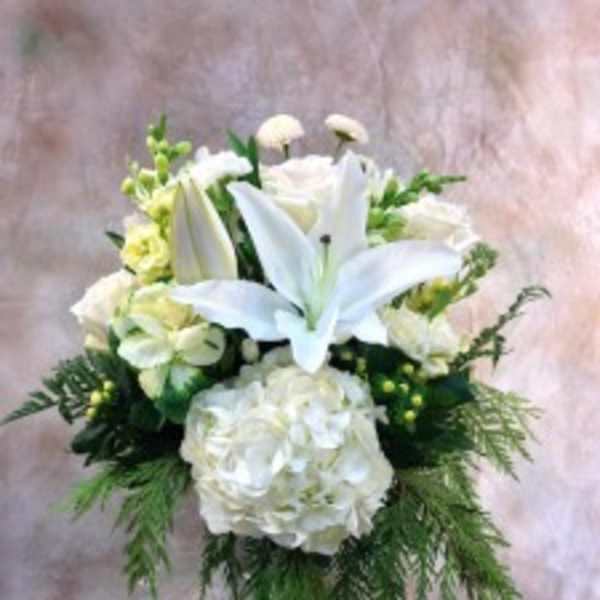 White lilies and hydrangeas in a glass vase