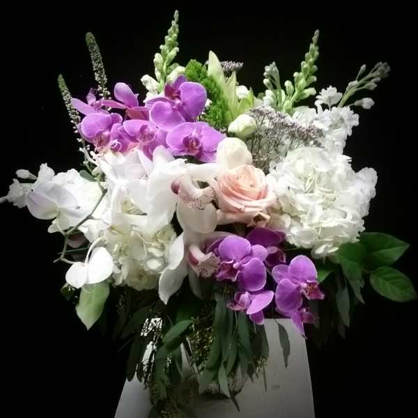 Bouquet of purple and white orchids with pale roses and hydrangeas