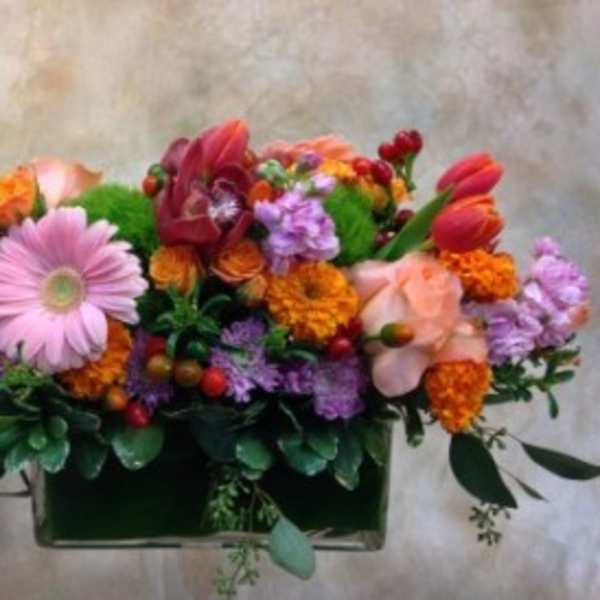 Mixed bouquet in a rectangular vase with pink and orange flowers