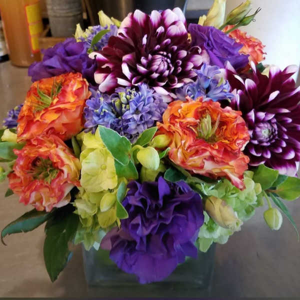 Colorful bouquet of dahlias and hydrangeas in a glass vase