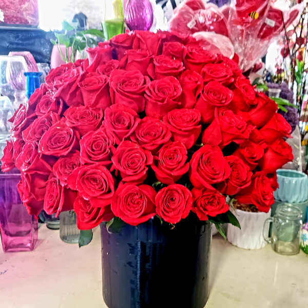 Large bouquet of red roses in a black vase