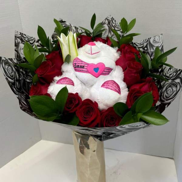 Bouquet of red roses with a white teddy bear in the center