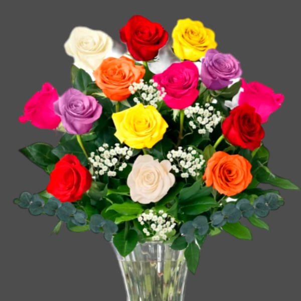 Colorful roses arranged in a clear glass vase