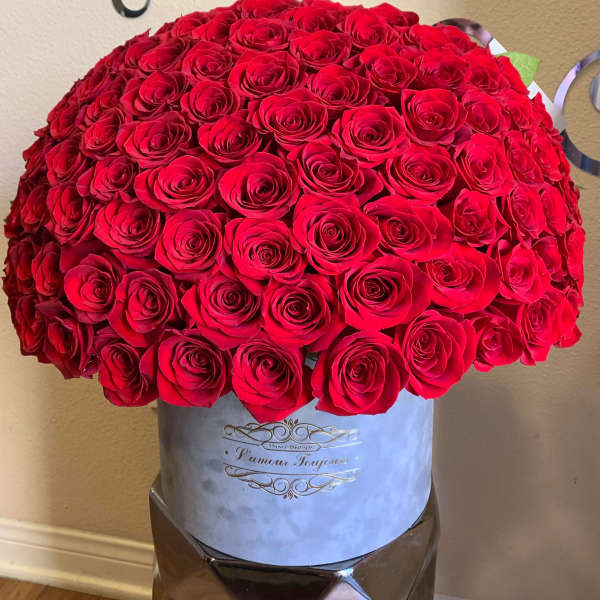 Large bouquet of red roses in a light blue hat box