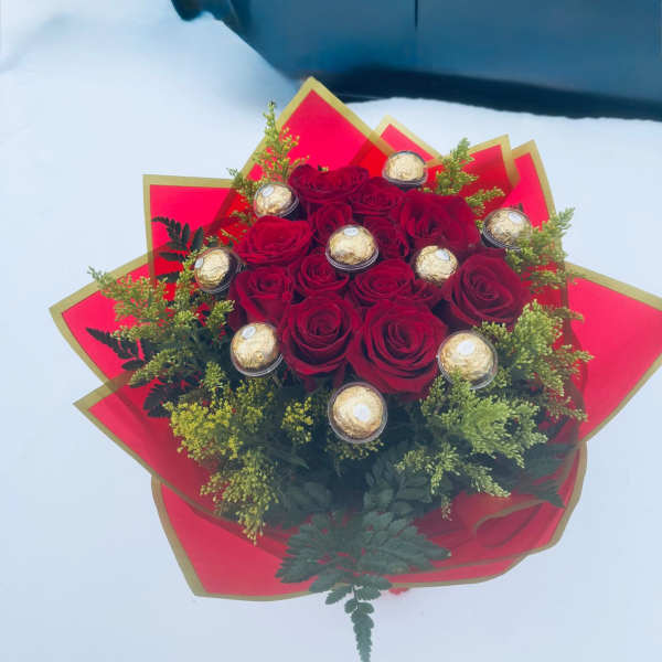 Red rose bouquet with gold-wrapped chocolates and red paper wrap