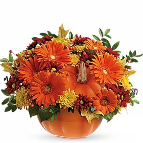 Orange pumpkin-shaped vase with orange and yellow flowers