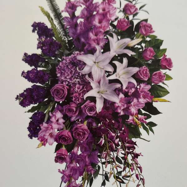 Purple floral standing spray with lilies and roses