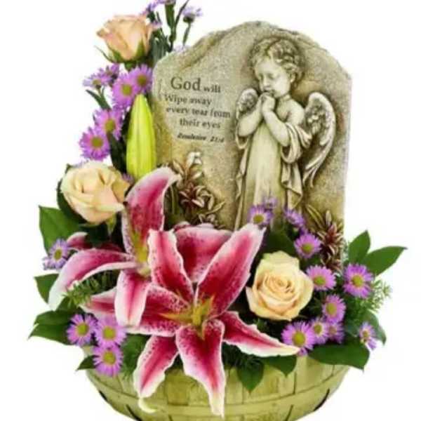 Basket arrangement with pink lilies, roses, and a memorial angel plaque