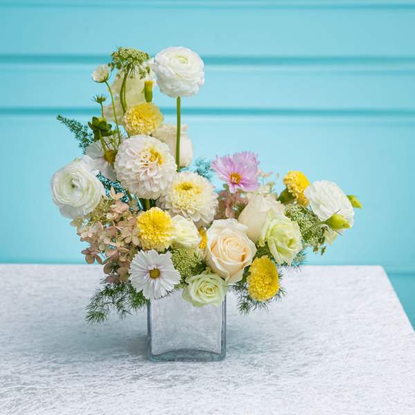 Mixed pastel flower arrangement in a clear glass vase