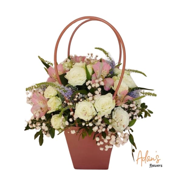 Basket arrangement of white roses and pink alstroemeria