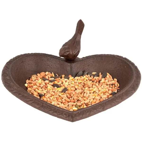 Heart-shaped bird feeder filled with mixed seeds
