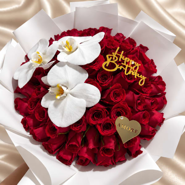 Round bouquet of red roses with white orchids and a birthday topper