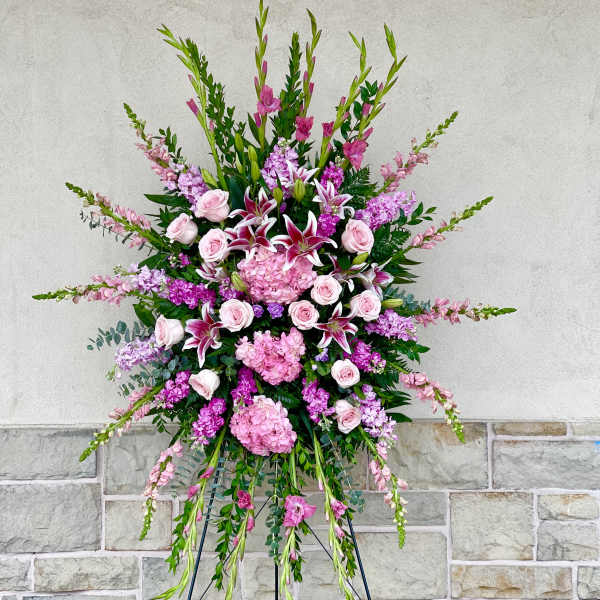 Large pink and white standing floral spray on an easel