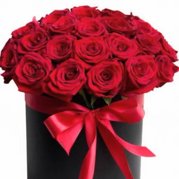 Red roses arranged in a black box with a red ribbon