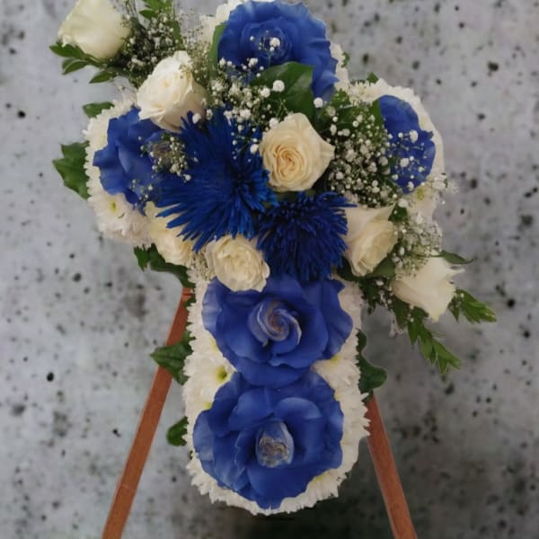 Blue and white floral arrangement on a wooden easel