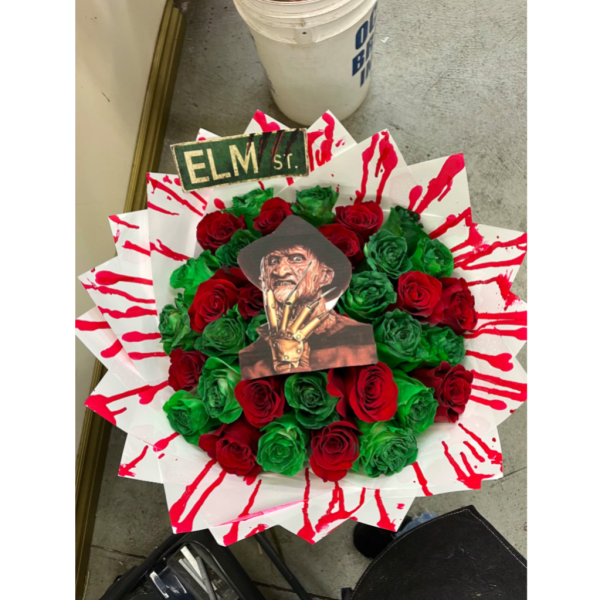 Bouquet of red and green roses with a horror character topper