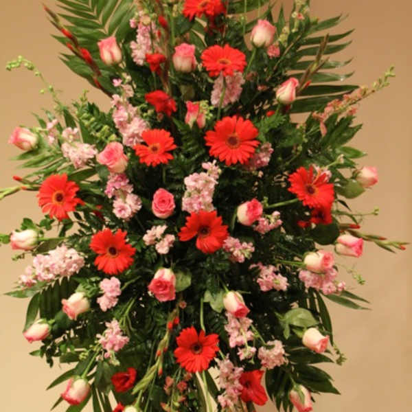 Tall floral spray with red gerbera daisies and pink roses