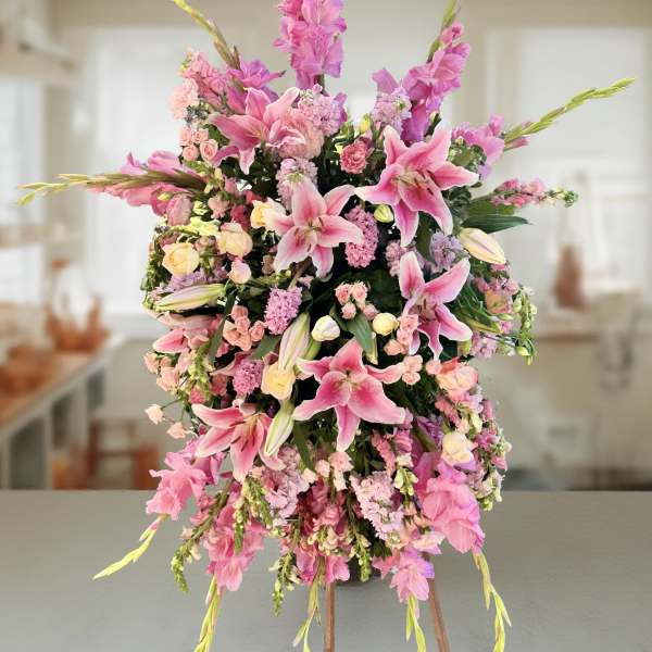 Tall pink floral arrangement with lilies and spray flowers