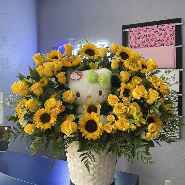 Yellow rose and sunflower arrangement with a Hello Kitty plush in a basket