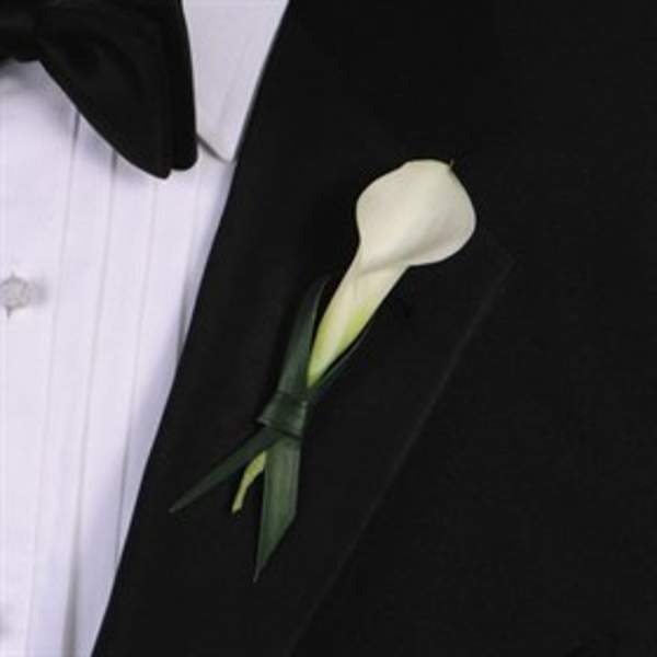 White calla lily boutonniere on a black suit jacket