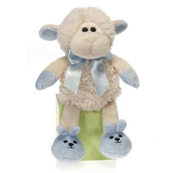 Plush sheep toy with a blue ribbon sitting on a green box