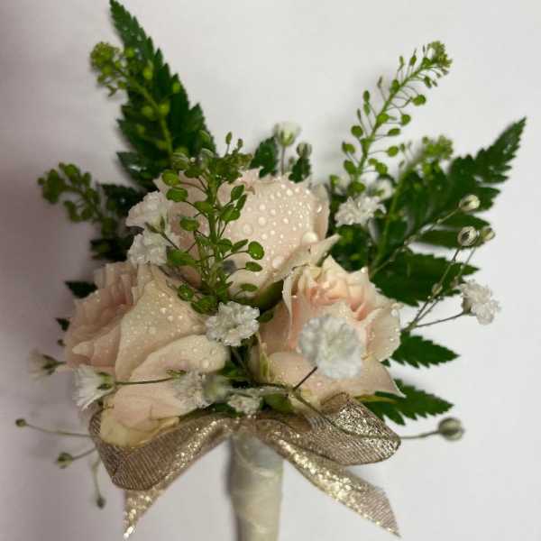 Small blush rose bouquet with white filler flowers and a gold ribbon wrap