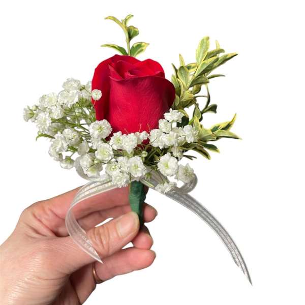 Red rose boutonniere with baby's breath and ribbon