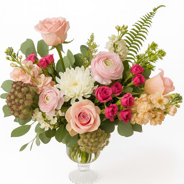 Mixed pink and white flowers arranged in a glass vase