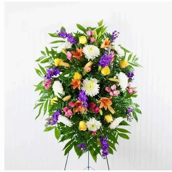 Standing floral spray with mixed yellow, white, purple, pink, and orange flowers