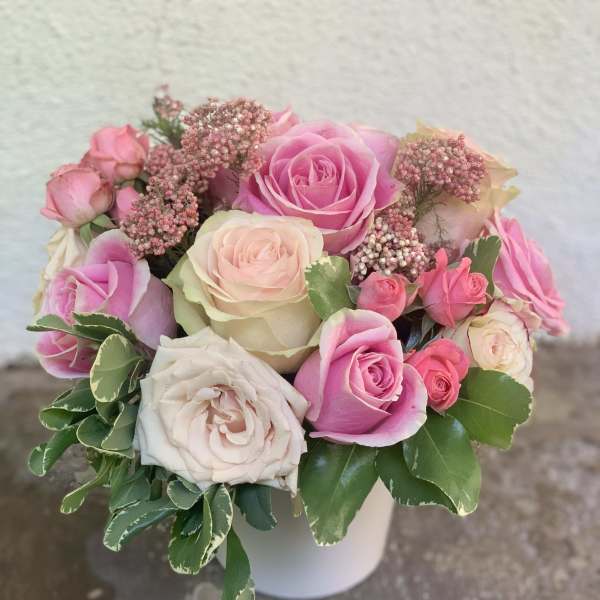 Pink and white rose bouquet in a white vase