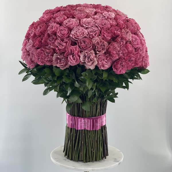Large dome bouquet of pink roses with a pink ribbon wrap