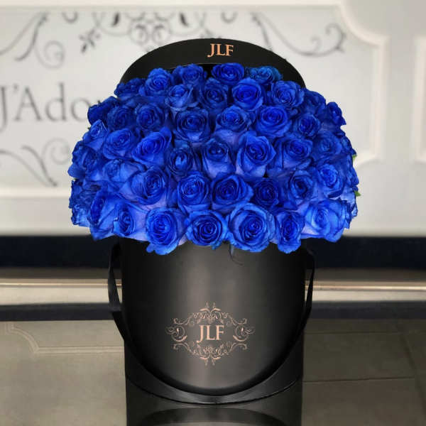 Large bouquet of vivid blue roses in a black hatbox