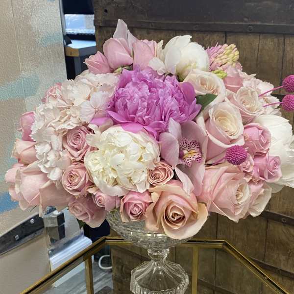 Pink and white floral arrangement in a clear glass vase