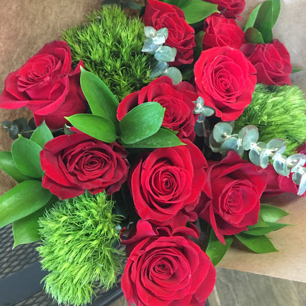 Bouquet of red roses with green filler and brown wrapping