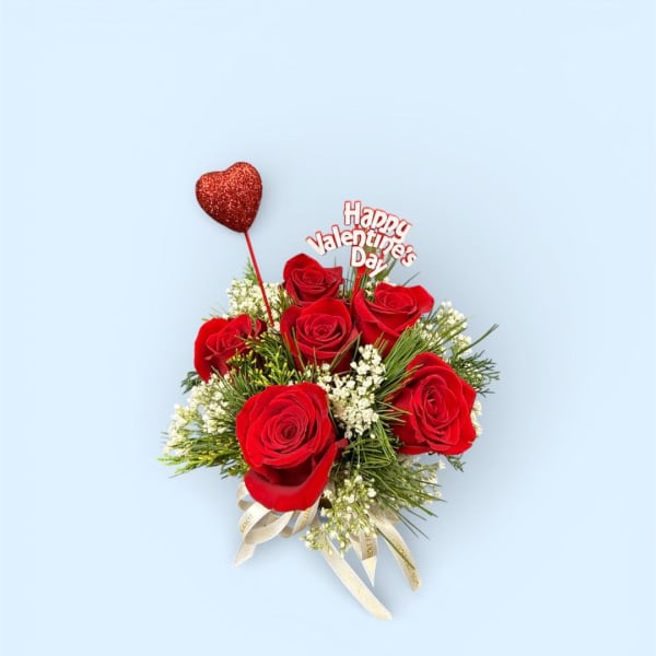 Red rose bouquet with a heart topper and Valentine's Day sign