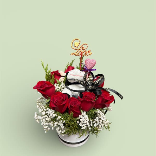 Red roses in a white box with a teddy bear and love topper