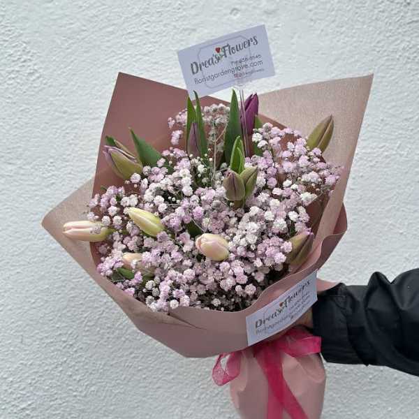 Pink tulip bouquet with baby's breath in pink wrapping