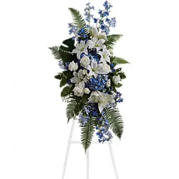 White and blue funeral spray on a standing easel