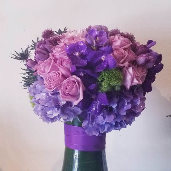Purple and pink bouquet in a glass vase