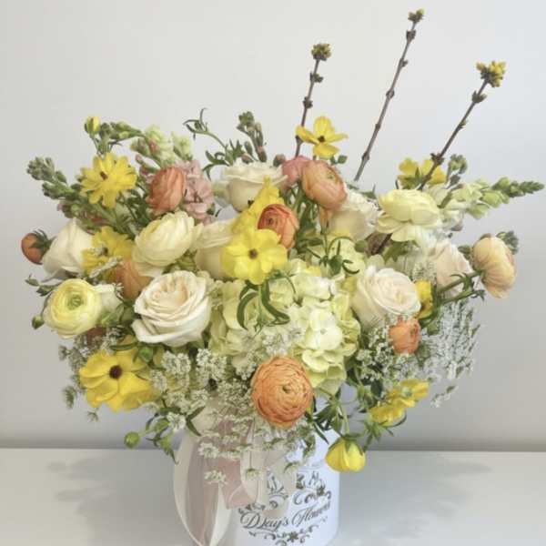 Mixed pastel bouquet in a white hatbox with a ribbon