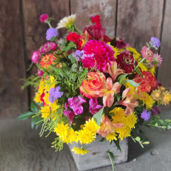 Colorful mixed bouquet in a white wooden box