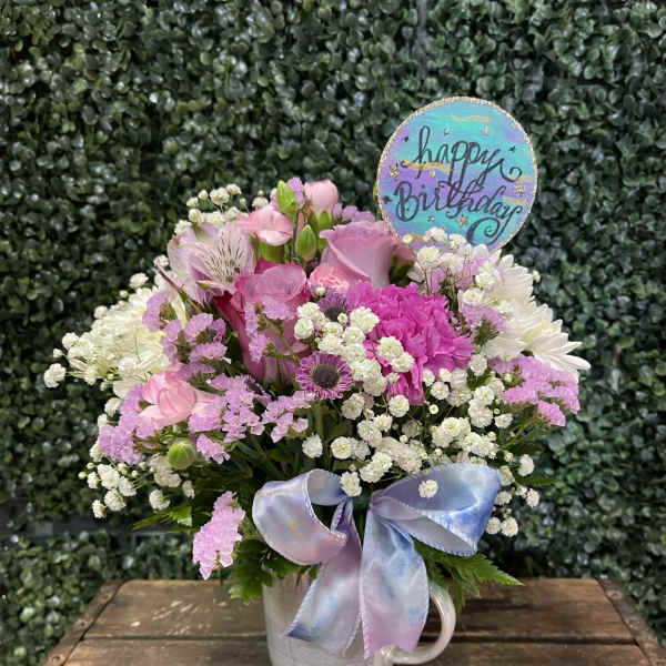 Pink and white mixed bouquet in a mug with a birthday sign and ribbon