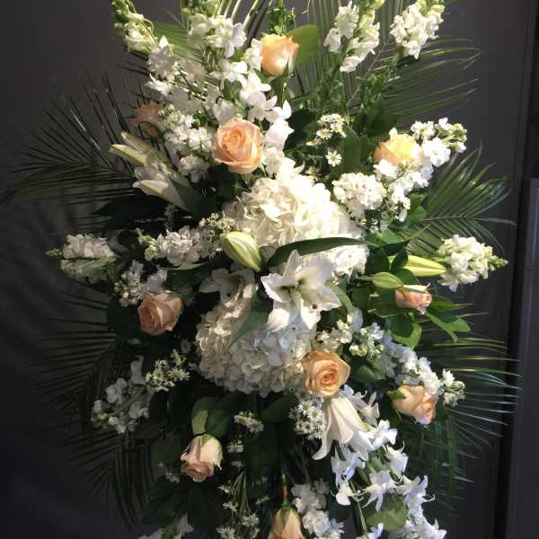 Tall white and peach floral standing spray with roses and lilies
