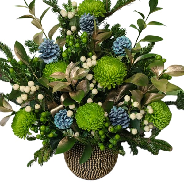 Green chrysanthemum arrangement with blue pinecones in a gold vase