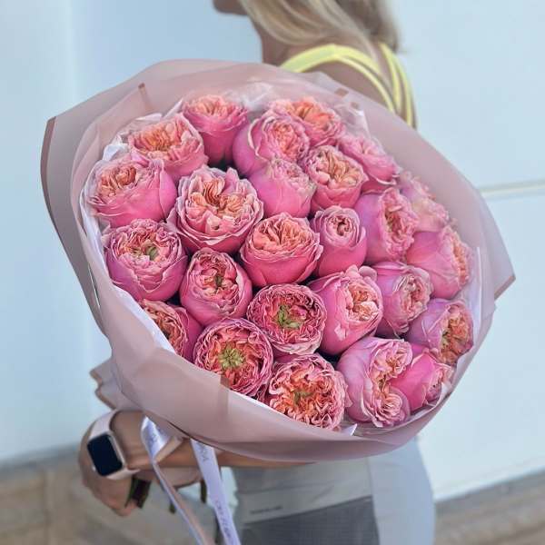Large bouquet of pink roses wrapped in blush paper
